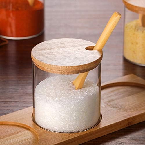 Исценети тегли за зачини со лажица ， шеќер сад со капаче и лажица сад со сол со капаче ， сад со сол шеќер поставен за сервирање